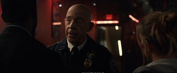 Movie still from “21 Bridges” (2019), directed by Brian Kirk – An older man in a police uniform looking at the camera; Close Up shot, Over the shoulder angle