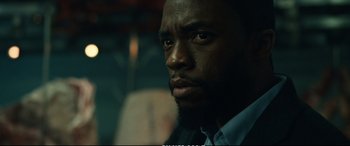 Movie still from “21 Bridges” (2019), directed by Brian Kirk – A person with a beard; Close Up shot, Low angle