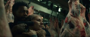 Movie still from “21 Bridges” (2019), directed by Brian Kirk – A man and a woman are on a train; Close Up shot, Over the shoulder angle