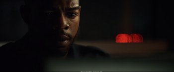 Movie still from “21 Bridges” (2019), directed by Brian Kirk – A person looking at a computer screen; Close Up shot, Over the shoulder angle