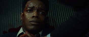 Movie still from “21 Bridges” (2019), directed by Brian Kirk – A person wearing a suit and tie; Close Up shot, Overhead angle