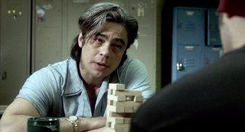 Movie still from “21 Grams” (2003), directed by Alejandro G. Iñárritu – A man sitting in front of a tower made out of blocks; Close Up shot, Over the shoulder angle