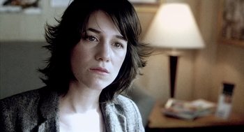 Movie still from “21 Grams” (2003), directed by Alejandro G. Iñárritu – A person wearing a sweater near a lamp; Close Up shot, Over the shoulder angle