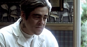 Movie still from “21 Grams” (2003), directed by Alejandro G. Iñárritu – A man in a white shirt is looking at the camera; Close Up shot, Low angle