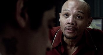 Movie still from “21 Grams” (2003), directed by Alejandro G. Iñárritu – A bald man with a goatee looking into a mirror; Close Up shot, Over the shoulder angle