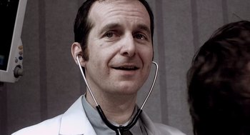 Movie still from “21 Grams” (2003), directed by Alejandro G. Iñárritu – A man with a stethoscope around his neck; Close Up shot, Low angle