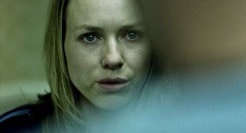 Movie still from “21 Grams” (2003), directed by Alejandro G. Iñárritu – A woman's face in a room; Extreme Close Up shot, Over the shoulder angle