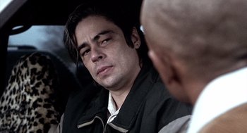 Movie still from “21 Grams” (2003), directed by Alejandro G. Iñárritu – A person sitting down with his eyes closed; Close Up shot, Over the shoulder angle