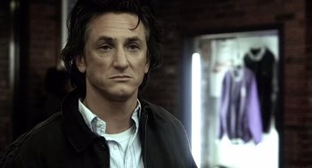 Movie still from “21 Grams” (2003), directed by Alejandro G. Iñárritu – A person wearing a black jacket; Close Up shot, Over the shoulder angle