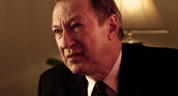 Movie still from “21 Grams” (2003), directed by Alejandro G. Iñárritu – An older man wearing a suit and tie; Close Up shot, Over the shoulder angle