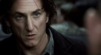 Movie still from “21 Grams” (2003), directed by Alejandro G. Iñárritu – A man's face in a black jacket; Close Up shot, Over the shoulder angle