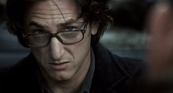 Movie still from “21 Grams” (2003), directed by Alejandro G. Iñárritu – A person wearing glasses and a jacket; Close Up shot, Low angle