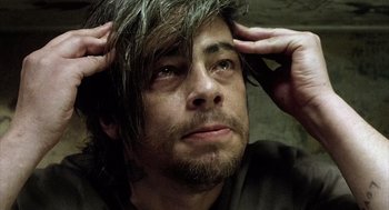 Movie still from “21 Grams” (2003), directed by Alejandro G. Iñárritu – A person holding his head; Close Up shot, Overhead angle