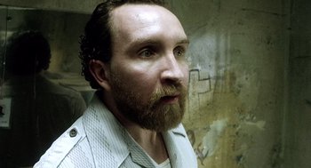 Movie still from “21 Grams” (2003), directed by Alejandro G. Iñárritu – A person with a beard; Close Up shot, Over the shoulder angle