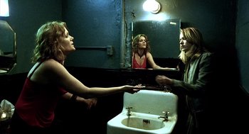 Movie still from “21 Grams” (2003), directed by Alejandro G. Iñárritu – Two women in front of a bathroom mirror and a sink; Medium shot, Over the shoulder angle