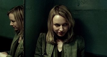 Movie still from “21 Grams” (2003), directed by Alejandro G. Iñárritu – A woman with blonde hair wearing a green jacket; Close Up shot, Low angle