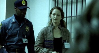 Movie still from “21 Grams” (2003), directed by Alejandro G. Iñárritu – A woman in a brown jacket and a man in a blue jacket; Medium shot, Over the shoulder angle