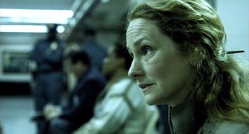 Movie still from “21 Grams” (2003), directed by Alejandro G. Iñárritu – A person sitting on a train; Close Up shot, Low angle
