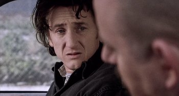 Movie still from “21 Grams” (2003), directed by Alejandro G. Iñárritu – A person looking at the camera; Close Up shot, Over the shoulder angle