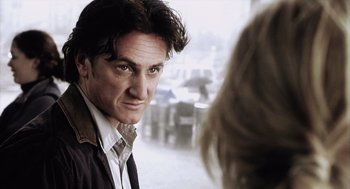 Movie still from “21 Grams” (2003), directed by Alejandro G. Iñárritu – A person wearing a suit and tie; Close Up shot, Over the shoulder angle
