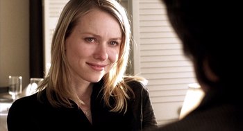 Movie still from “21 Grams” (2003), directed by Alejandro G. Iñárritu – A beautiful young blond woman smiling for the camera; Close Up shot, Over the shoulder angle