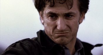 Movie still from “21 Grams” (2003), directed by Alejandro G. Iñárritu – A man's face with a sad look on his face; Close Up shot, Low angle