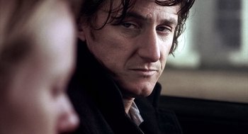 Movie still from “21 Grams” (2003), directed by Alejandro G. Iñárritu – A person wearing a black jacket; Close Up shot, Over the shoulder angle