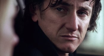 Movie still from “21 Grams” (2003), directed by Alejandro G. Iñárritu – A man's face in a black jacket; Close Up shot, Low angle