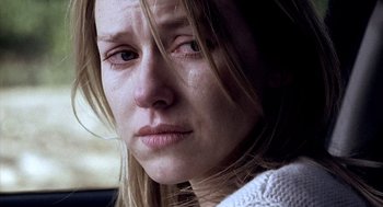 Movie still from “21 Grams” (2003), directed by Alejandro G. Iñárritu – A woman's face as she sits in a car; Close Up shot, Over the shoulder angle