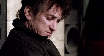 Movie still from “21 Grams” (2003), directed by Alejandro G. Iñárritu – A person wearing a black shirt; Close Up shot, Low angle