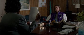 Movie still from “21 Jump Street” (2012), directed by Phil Lord – Two people sitting at a table with papers in front of them; Medium shot, Over the shoulder angle