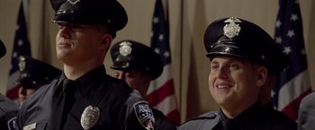 Movie still from “21 Jump Street” (2012), directed by Phil Lord – A group of police officers standing next to each other; Close Up shot, Over the shoulder angle