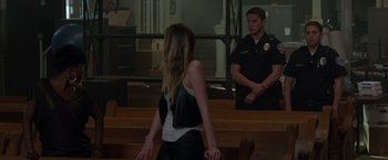 Movie still from “21 Jump Street” (2012), directed by Phil Lord – A woman standing in front of a man in front of a wooden bench; Wide shot, Over the shoulder angle