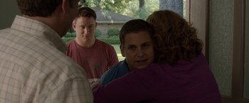Movie still from “21 Jump Street” (2012), directed by Phil Lord – A group of people standing next to each other in front of a tree; Medium shot, Over the shoulder angle