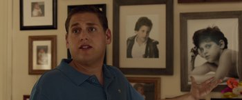 Movie still from “21 Jump Street” (2012), directed by Phil Lord – A man standing in front of a picture of a child; Close Up shot, Over the shoulder angle