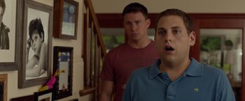 Movie still from “21 Jump Street” (2012), directed by Phil Lord – Two young men standing next to each other in front of a staircase; Close Up shot, Over the shoulder angle