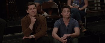Movie still from “21 Jump Street” (2012), directed by Phil Lord – Two young men sitting next to each other in front of a crowd; Medium shot, High angle
