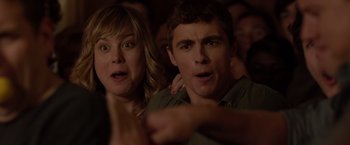 Movie still from “21 Jump Street” (2012), directed by Phil Lord – A man and a woman looking surprised in a crowd; Close Up shot, Over the shoulder angle