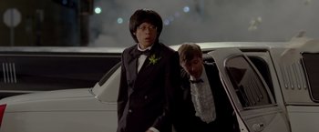Movie still from “21 Jump Street” (2012), directed by Phil Lord – Two young men in tuxedos standing in front of a limo; Medium shot, Low angle