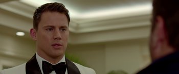 Movie still from “21 Jump Street” (2012), directed by Phil Lord – A man in a tuxedo is looking at the camera; Close Up shot, Over the shoulder angle