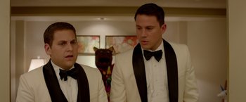 Movie still from “21 Jump Street” (2012), directed by Phil Lord – Two men in tuxedos standing next to each other; Close Up shot, Over the shoulder angle
