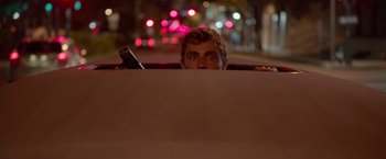 Movie still from “21 Jump Street” (2012), directed by Phil Lord – A young man in the back seat of a car at night; Close Up shot, Low angle