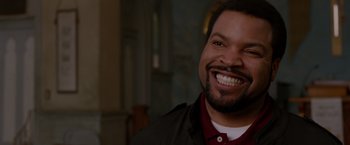 Movie still from “21 Jump Street” (2012), directed by Phil Lord – A person with a beard smiling; Close Up shot, Over the shoulder angle