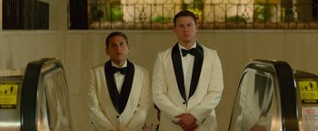 Movie still from “21 Jump Street” (2012), directed by Phil Lord – A couple of men standing next to each other in tuxedos; Medium shot, Low angle