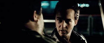 Movie still from “25th Hour” (2002), directed by Spike Lee – A man in a leather jacket looking at another man in a leather jacket; Close Up shot, Over the shoulder angle