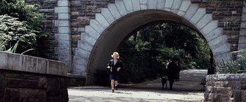 Movie still from “25th Hour” (2002), directed by Spike Lee – A woman walking down a street with a dog; Wide shot, Over the shoulder angle