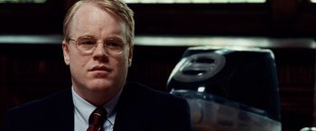 Movie still from “25th Hour” (2002), directed by Spike Lee – A person wearing a suit and tie; Close Up shot, Over the shoulder angle