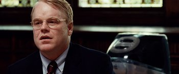 Movie still from “25th Hour” (2002), directed by Spike Lee – A person wearing a suit and tie; Close Up shot, Over the shoulder angle