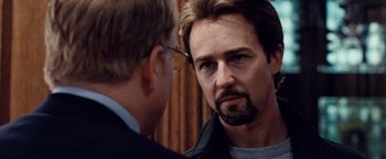Movie still from “25th Hour” (2002), directed by Spike Lee – A man with a goatee is talking to another man; Close Up shot, Over the shoulder angle