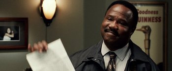 Movie still from “25th Hour” (2002), directed by Spike Lee – A man wearing a black jacket and a black tie; Close Up shot, Over the shoulder angle